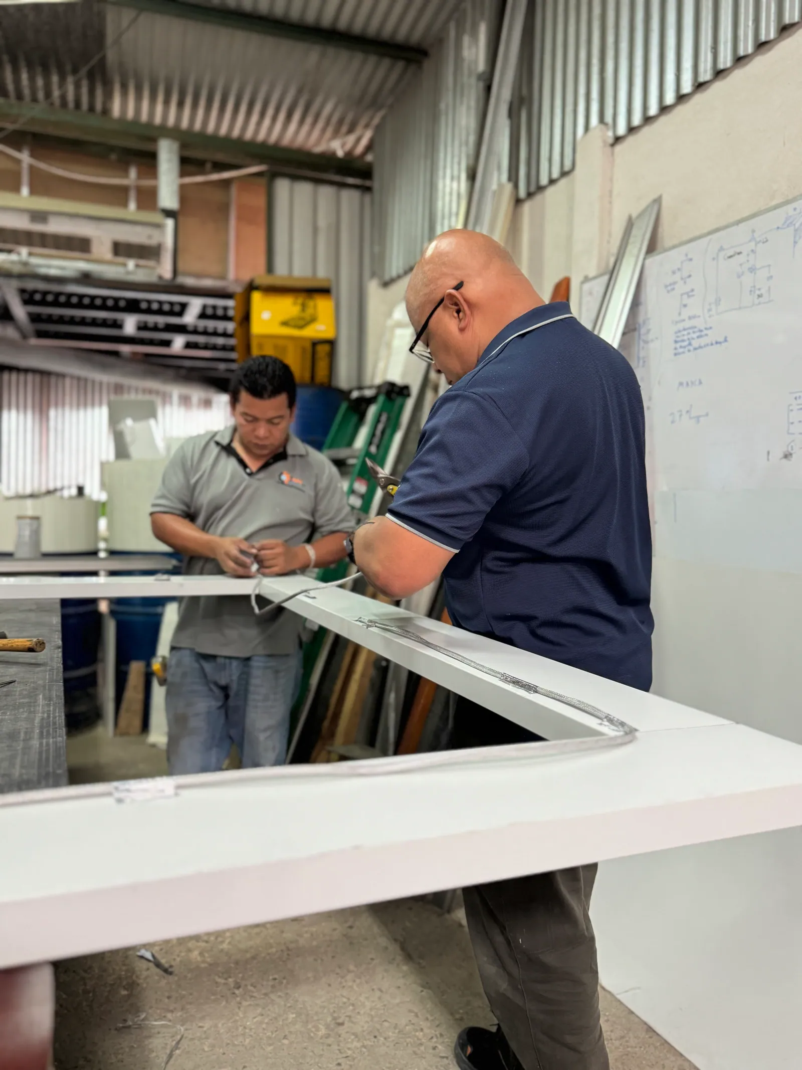 Técnicos de INPRE ensamblando una puerta frigorífica en el taller